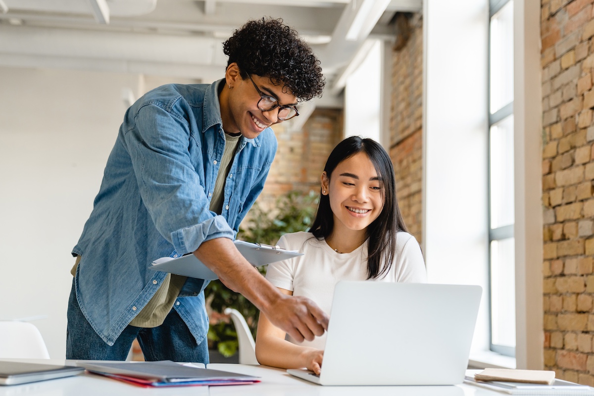 Two people looking at a laptop